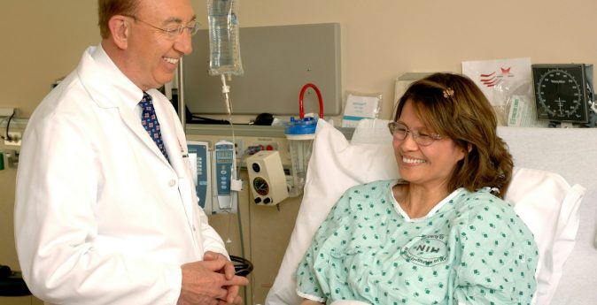 Photo by National Cancer Institute Patient and doctor in hospital room
